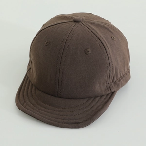 Detailed side view of dark brown kids short brim baseball cap with breathable eyelets