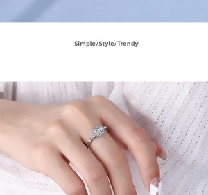 Close-up of silver ring with halo cushion-cut cubic zirconia and micro-pave setting