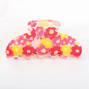 Fresh acrylic hair claw clip with pink and yellow floral patterns on a translucent base