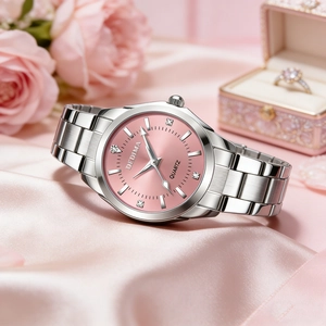 Elegant women's quartz watch with pink dial and silver metal strap on pink silk fabric