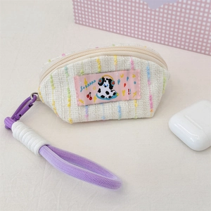 Close-up of creamy tweed earphone case with cute dalmatian patch and purple strap