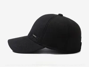 Side view detail of a black winter baseball cap featuring SPORT embroidery and ear flaps