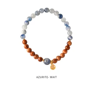 Macro detail of beaded bracelet with azurite stones and golden Fu character pendant