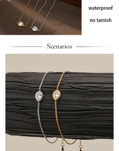 Close-up of teardrop zircon pendants on gold and silver waterproof stainless steel chains