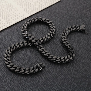 Close-up of black stainless steel Cuban chain necklace on textured leather surface
