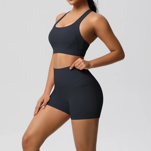 Detail of high-waisted black yoga shorts with practical side pockets for sports essentials