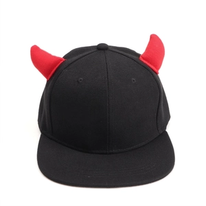 Detail of black snapback hat featuring 3D red devil horns and breathable eyelets