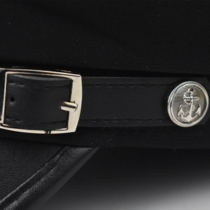 Detailed close-up of a captain hat showing leather strap and silver anchor button