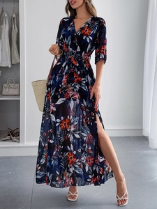 Detail of elegant V-neck floral maxi dress in navy blue with waist tie and side split