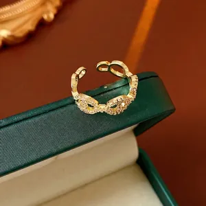 Luxury gold plated bow ring with micro-set zircons on green velvet box display