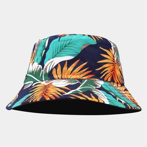 Close-up of tropical palm leaf print on navy blue reversible wide brim bucket hat
