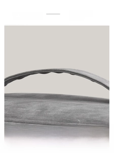 Detail of the soft curved gray handle with elegant grainy texture for comfortable grip