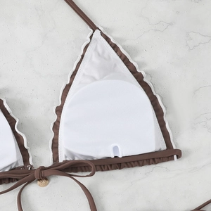 Detail of brown bikini top with white ruffle trim and removable white breast pads