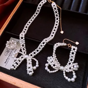 Elegant pearl jewelry set featuring woven bow necklaces and bracelets with gold accents