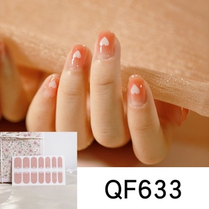 Close-up of pink heart gradient nail stickers with peach accents and glossy finish