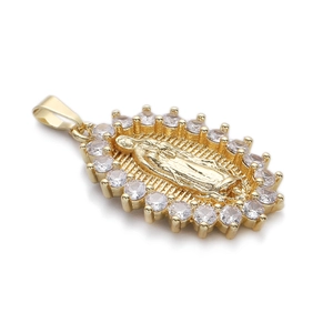 Macro view of 14K gold plated Virgin Mary oval pendant with sparkling zircon inlay