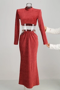 Detailed view of red pleated fabric texture on a long-sleeve crop top and maxi skirt set