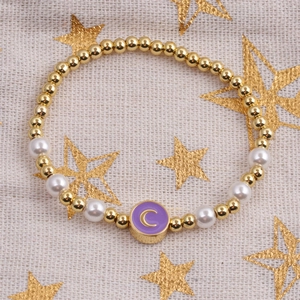 Gold beaded bracelet with pearls and a purple letter C enamel moon charm