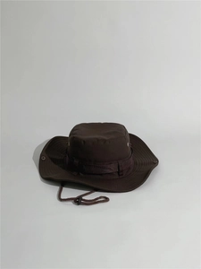 Close-up of a brown outdoor boonie hat with adjustable chin strap and vent eyelets