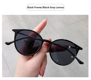 Macro shot of retro black round frame sunglasses showing the 9328 model code detail