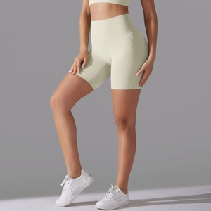 Close-up of high-waist cream yoga shorts featuring seamless front and matte elastic fabric