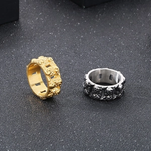 Detail of vintage punk skull rings in gold and silver finish with embossed textures