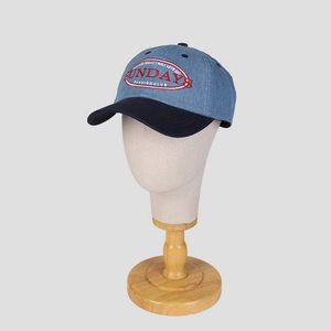 Close-up of red and white SUNDAYS RUNNING CLUB embroidery on denim baseball cap
