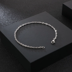 Macro detail of silver rope chain link texture and high-quality lobster clasp closure