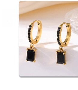 Macro detail of 18K gold plated square drop earrings with black cubic zirconia accents