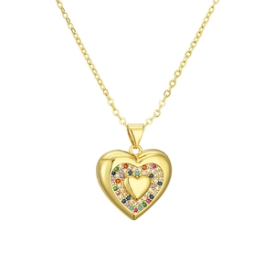 Macro detail of gold heart pendant featuring vibrant rainbow cubic zirconia settings