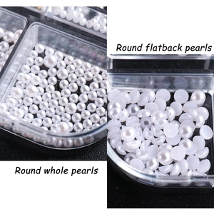 Macro detail of white round whole pearls and flatback pearls in clear storage organizer