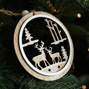 Wooden Christmas ornament with reindeer cutout hanging on a tree with festive lights