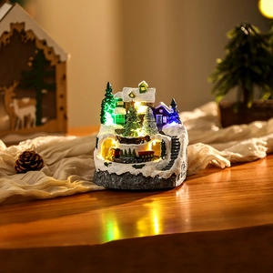 Close-up of a lit Christmas snow house with a small train tunnel and festive LED lights