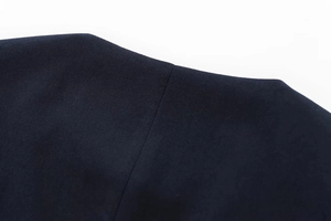 Macro shot of dark blue textured fabric with precise stitching and high-quality weave