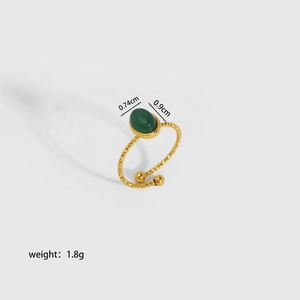 Detail of 18K gold stainless steel ring featuring a green natural stone and beaded band
