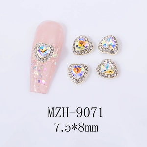 Detail view of 7.5x8mm aurora heart nail charms with gold alloy base and crystal accents