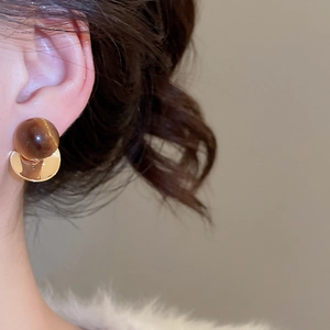 Detail of tiger eye stone earrings with 18k gold plated fringe and geometric design