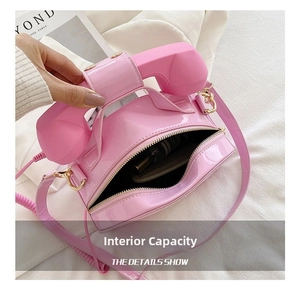 Pink creative telephone-shaped bag showing internal capacity with crossbody strap