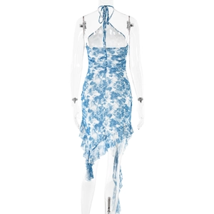 Detail of blue and white tie-dye dress featuring halter backless design and ruffles