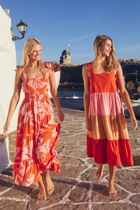 Detail of elegant backless summer dresses with vibrant floral prints and tie-up shoulder straps