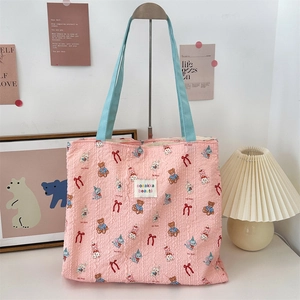 Pink canvas tote bag featuring cute cartoon rabbit and bear prints with soft blue straps