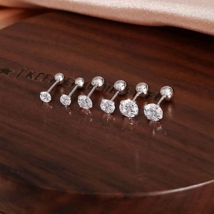 Macro shot of 925 silver stud earrings set with six sizes of sparkling round zircons