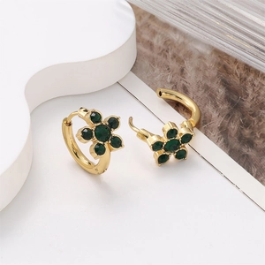 Detailed close-up of 18k gold plated flower earrings with five green zircon stones