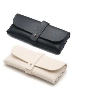 Black and cream lychee grain leather glasses cases with gold metal snap buttons