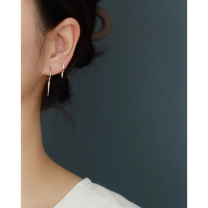 Macro shot of S925 silver rivet spike earrings with crystal inlay for stacked piercing