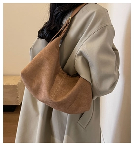 Brown suede tote bag styled with a beige trench coat for a vintage commute look