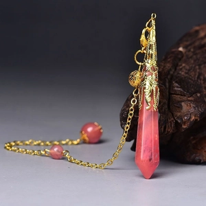 Detail of pink strawberry crystal pendulum pendant with golden filigree cap and fine chain
