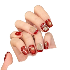 Handmade red and gold festive press-on nails with fireworks and pearl embellishments