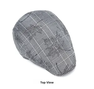 Top view of British style flat cap featuring grey plaid fabric and black leaf pattern