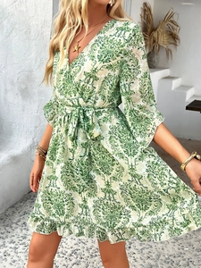 Detail of bohemian paisley print chiffon dress with V-neckline and ruffled hemline